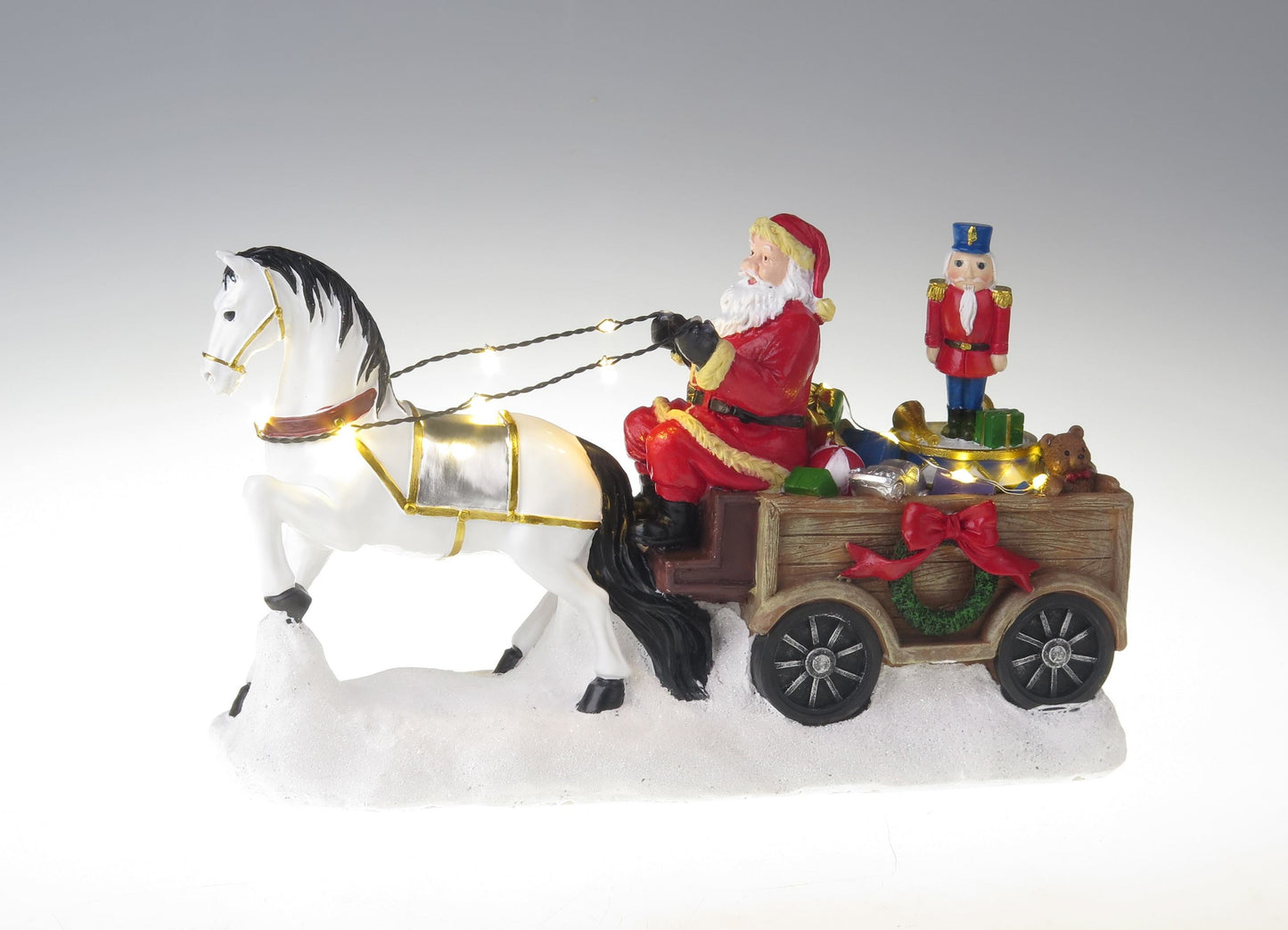 Papá Noel con caballo blanco, carreta y cascanueces giratorios.