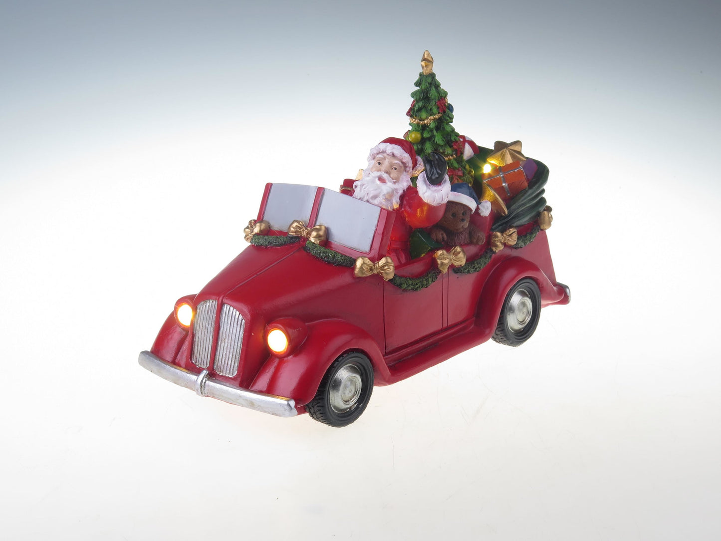 Santa en coche con árbol giratorio