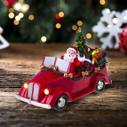 Santa en coche con árbol giratorio